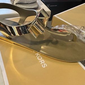 Gold Micheal Kors thong style sandal